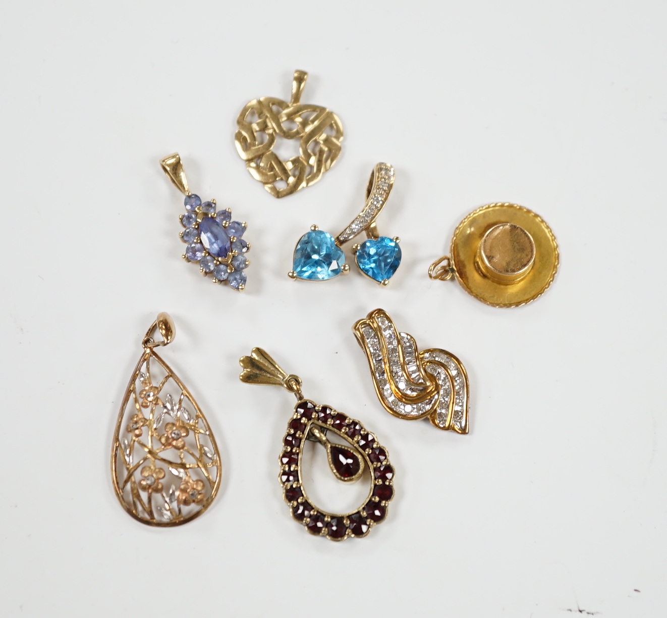 Seven assorted modern mainly 9ct and gem set small pendants, including diamond chip cluster, gross weight 10.4 grams.